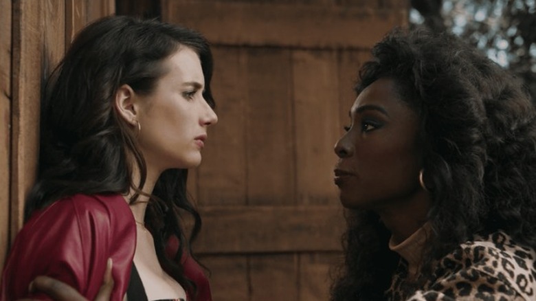 Emma Roberts and Angelica Ross facing one another in AHS 1984