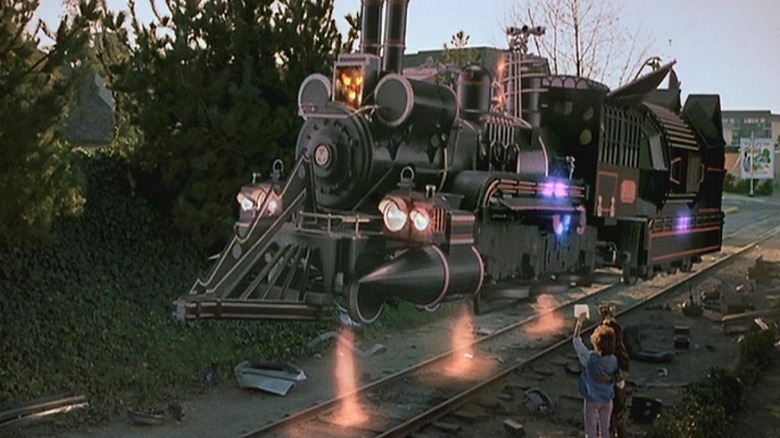 people wave to a train taking off into the air
