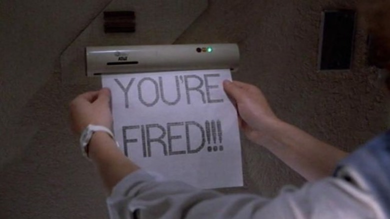 hands reach for printout reading "YOU'RE FIRED!!!"