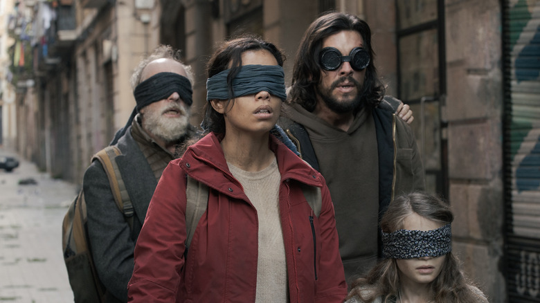 Blindfolded group walking through Barcelona