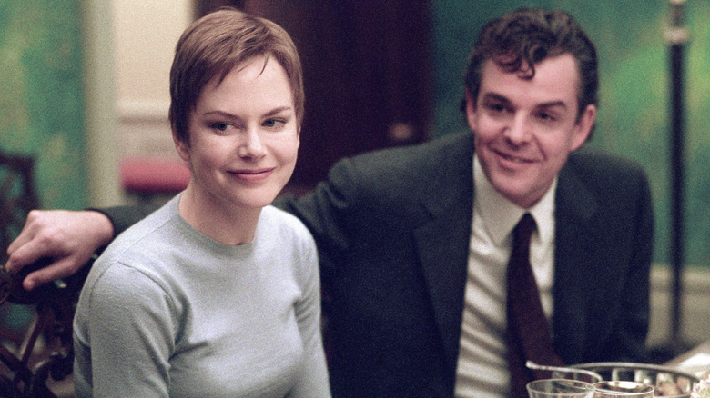 Joseph and Anna smiling at a dinner table in "Birth" (2004)