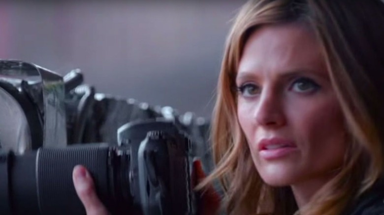 Beckett holds a camera