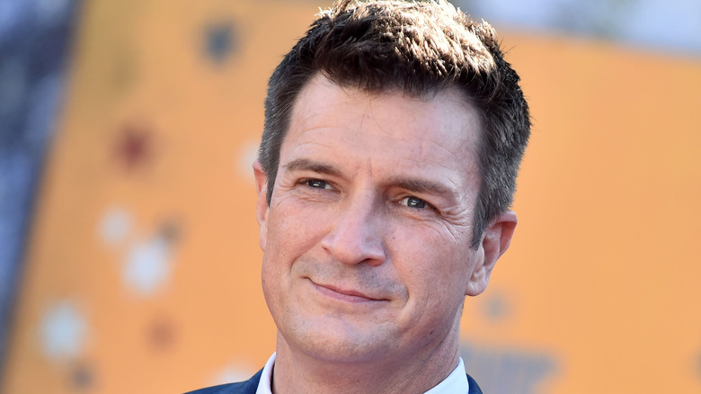 Nathan Fillion smiles at movie premier