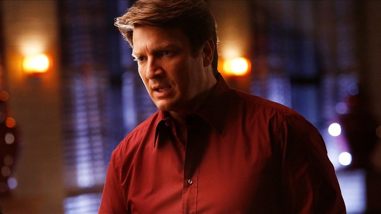 Richard Castle looking upset while talking