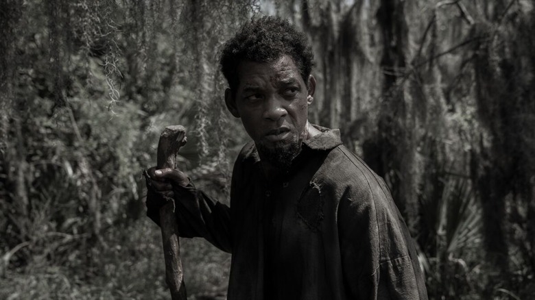 Peter wades through a swamp