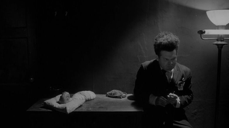 Henry Spencer sitting next to deformed baby