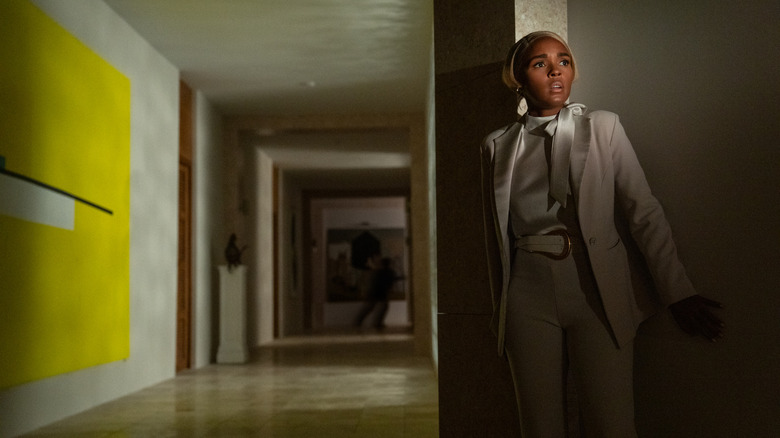 Helen/"Andi" hides behind a wall