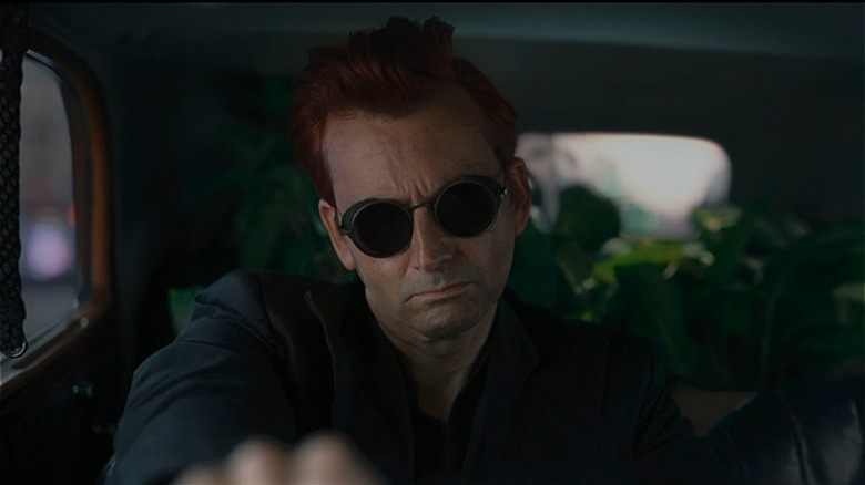 Crowley wearing shades and driving