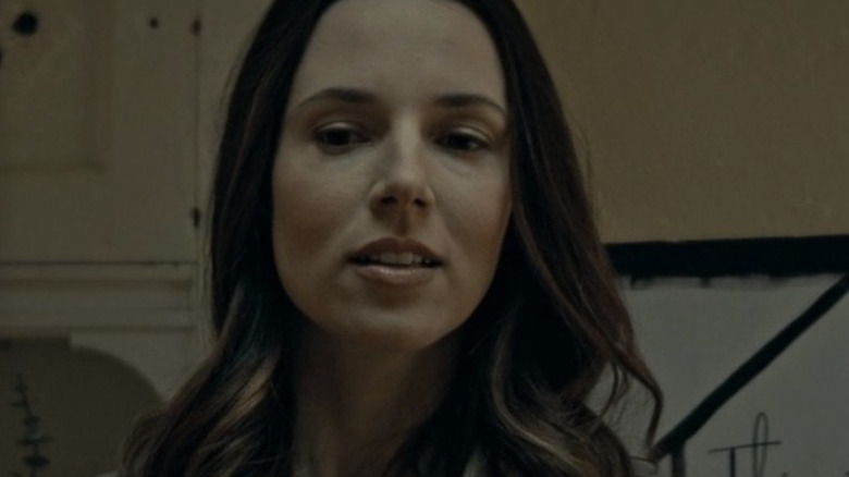 Melinda with a small smile