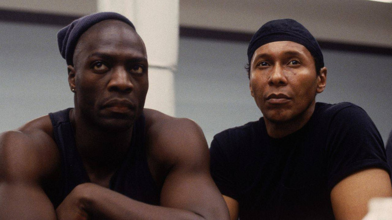Simon and gang member look on