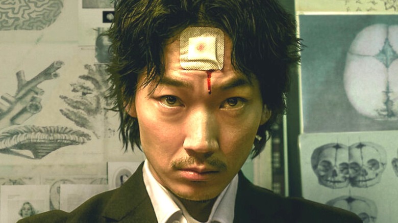 Nakoshi with bloody bandage on forehead