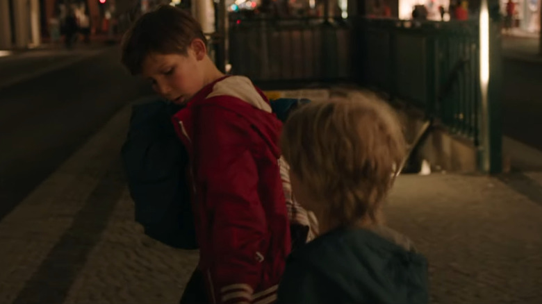 Jack leads Manuel down a busy city street in "Jack" (2014)