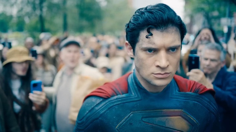 Superman scowling as he walks through a crowd in "Superman" (2025)