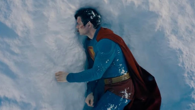 Superman lies injured in the snow in "Superman" (2025)