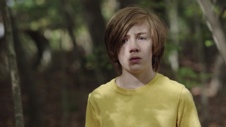 John is walking in the woods