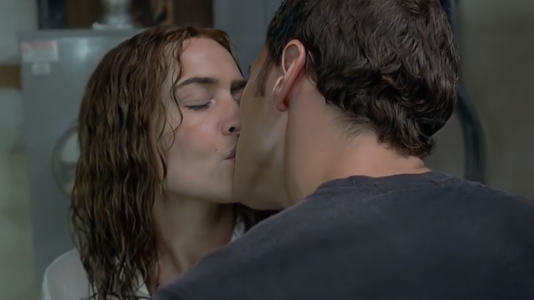 Sarah kissing Brad in laundry room