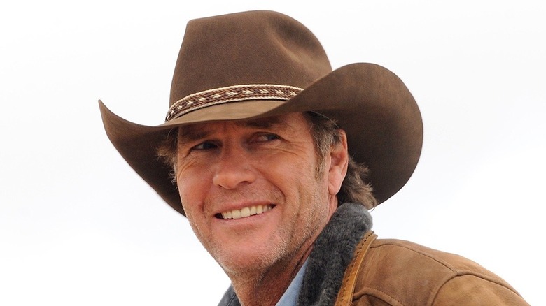 Longmire smiles into distance