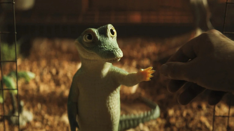 Baby Lyle touching Hector's hand