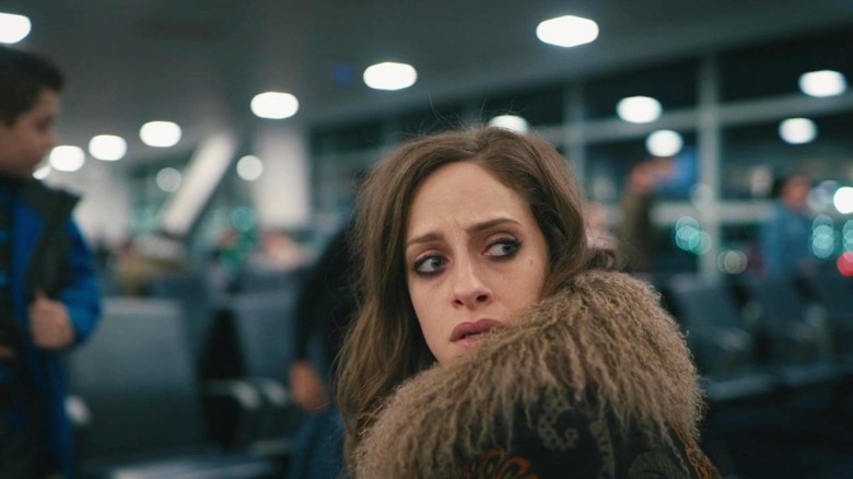 Darlene sitting in airport looking over her shoulder