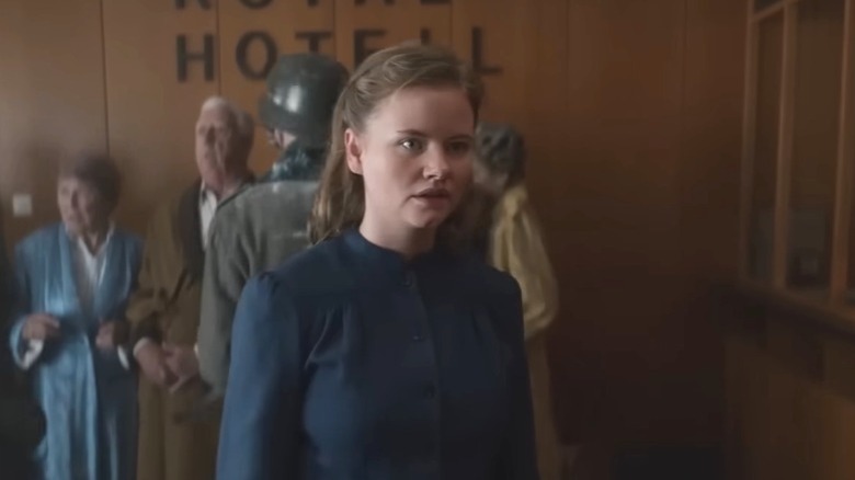 Ingrid standing in crowded hotel lobby