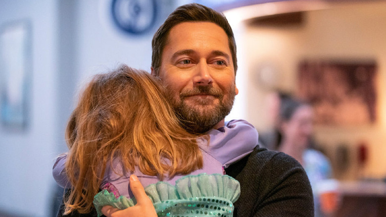 Max Goodwin holding his daughter