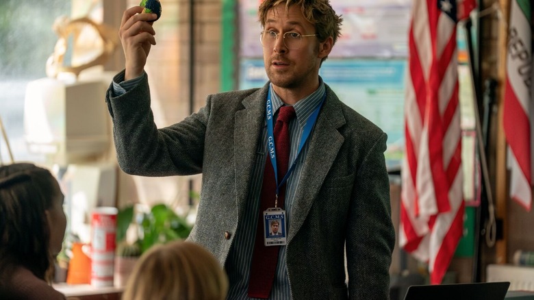 Ryland holding an Earth hackysack in his classroom in Project Hail Mary