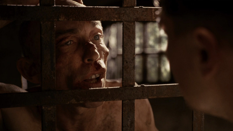 Teddy talking to George Noyce behind bars