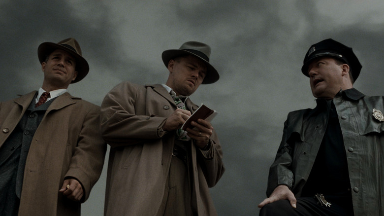 Chuck and Teddy talking to a police officer outside