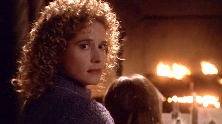 Intense Nancy Travis by fireplace