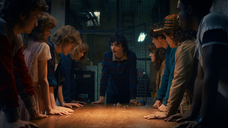 The Hawkins gang gathers by a map in "Stranger Things"