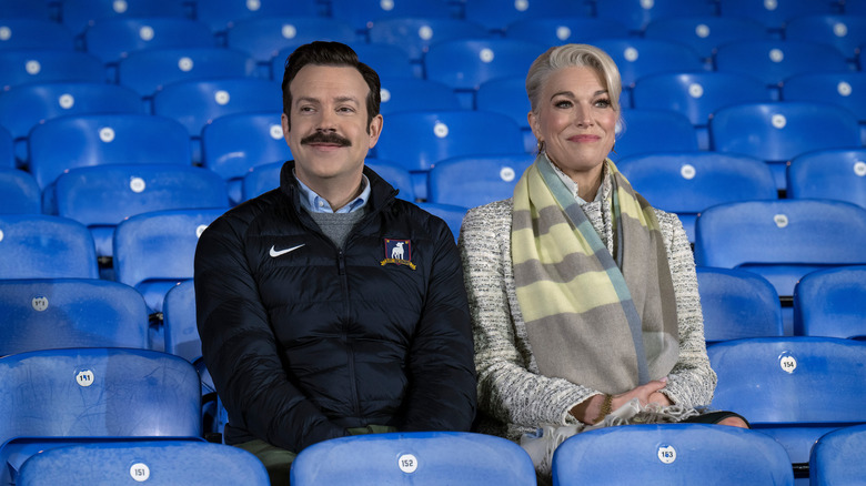 Ted and Rebecca sitting in blue stands