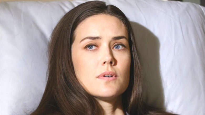 Megan Boone sitting up in bed