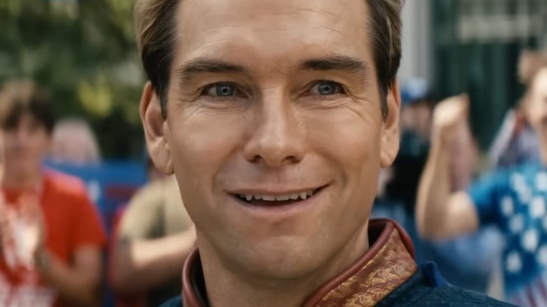 Homelander smiling in front of a cheering crowd