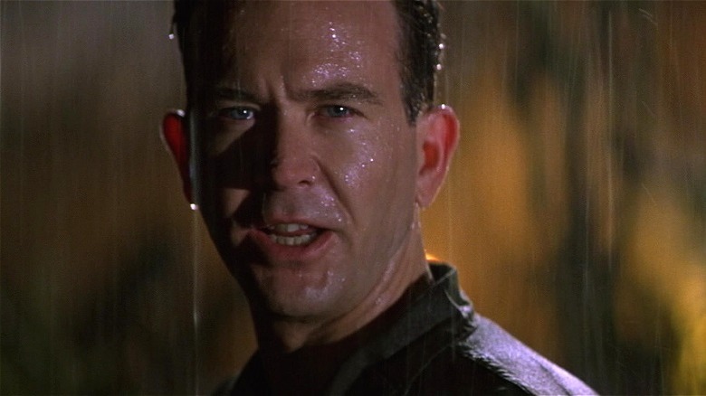 Colonel Kent frowning in the rain in The General's Daughter