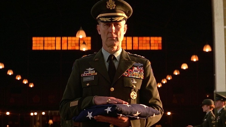 General Campbell carrying flag somberly