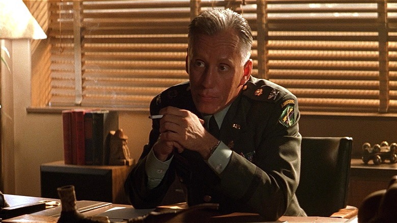 Moore smoking at his desk in The General's Daughter