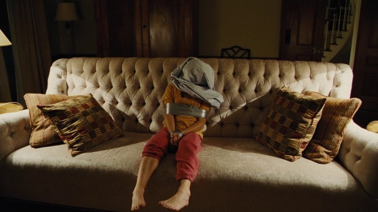 Bob sits on the couch after being shot