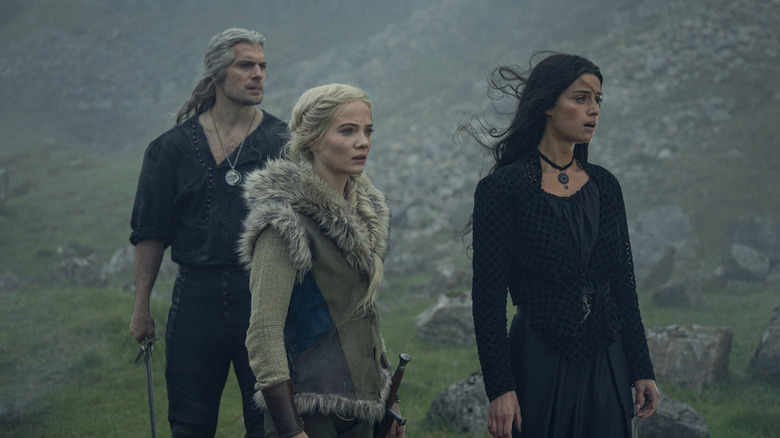 Geralt, Ciri, and Yennefer walking outside