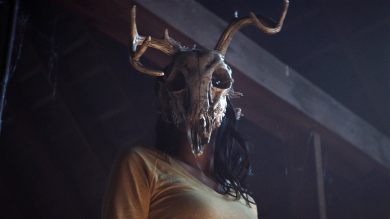 The witch as Sara wearing a deer skull