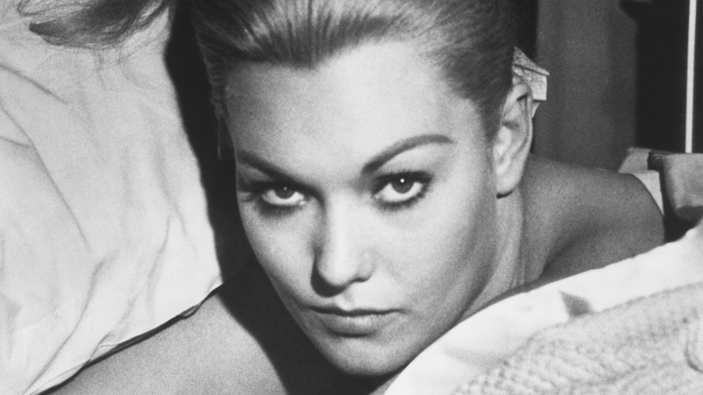Kim Novak looking up in bed in 
