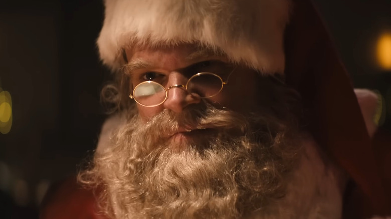 David Harbour as Santa Claus sitting at the bar