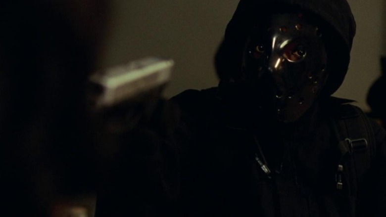 Masked Veronica pointing gun