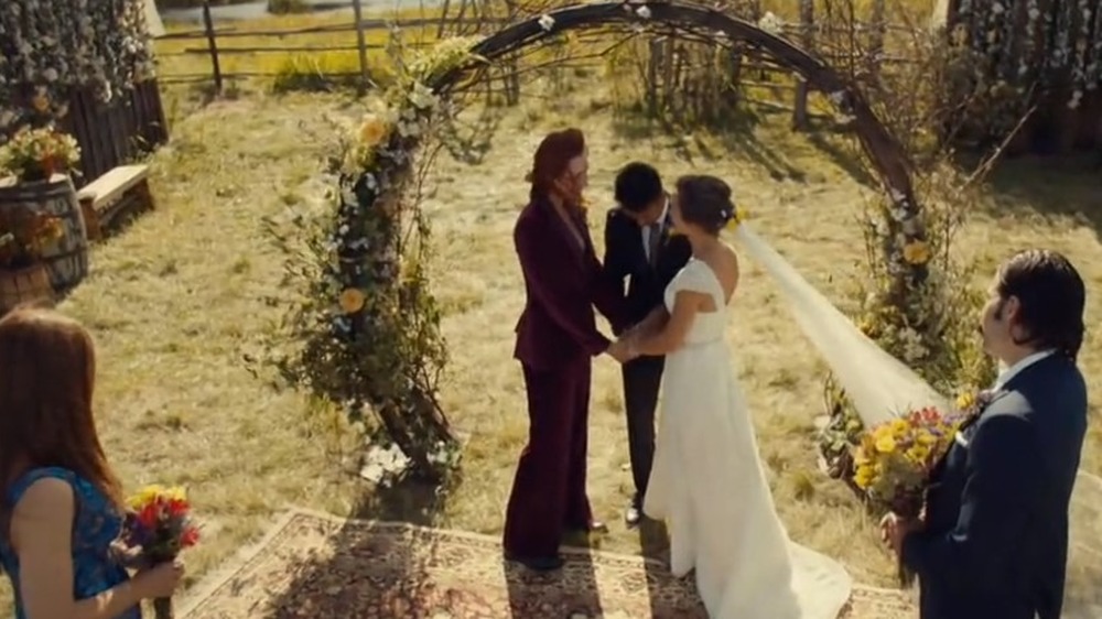 Wynonna and Doc stand beside Nicole and Waverly during the ceremony
