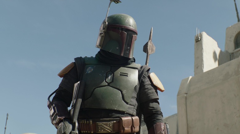 Boba Fett stands in Mos Espa