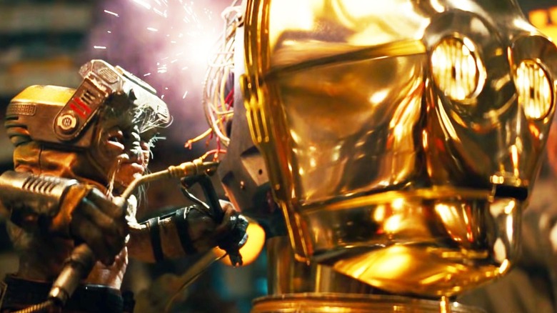 Babu Frik tinker's with C-3PO's head