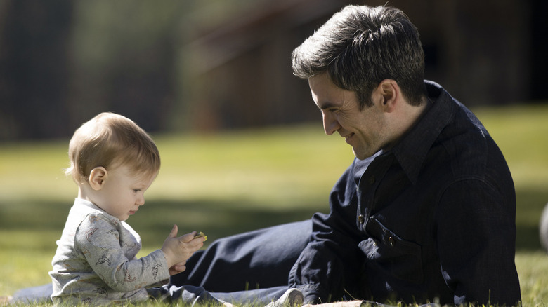 Jamie looks at his baby