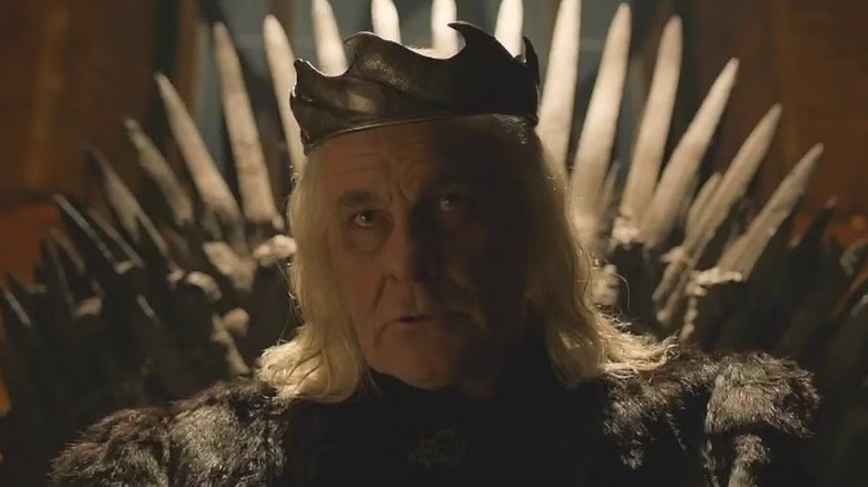 Aerys II sitting on the Iron Throne in a crown on Game of Thrones