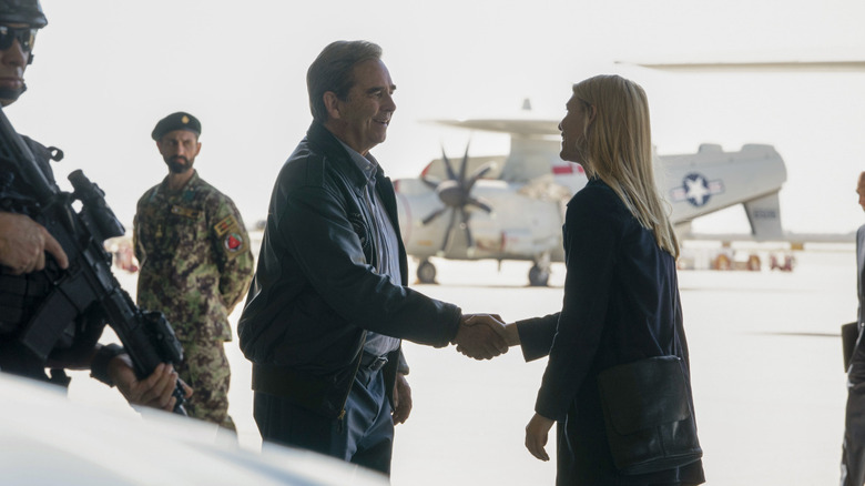 President Warner shaking Carrie Mathison's hand