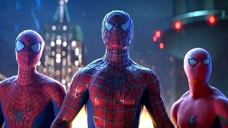 All three Spider-Men next to each other in front of tall buildings in "Spider-Man: No Way Home" (2021)