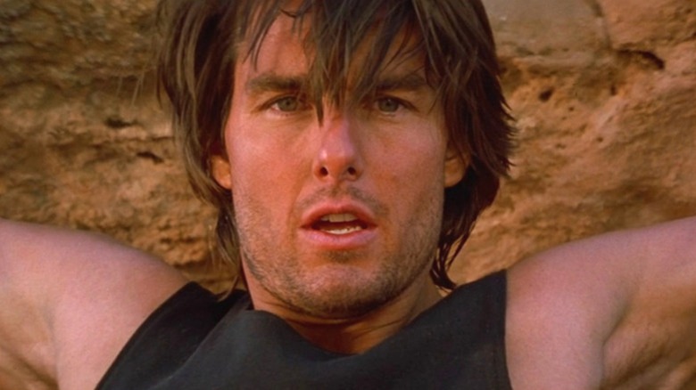 Ethan Hunt hanging from cliffside in Mission: Impossible 2 (2000)